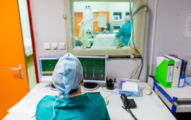 Surgical team operating a patient in an operation theater. Surgeon at work in the hospital. Medicine doctor. Cardiac surgery. Heart transplantation. Surgical equipment and instruments.