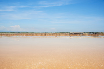 Scene of salt pan field on blue sky background