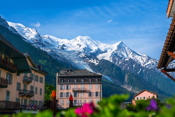 Breathtaking scenery of the Alps from Chamonix France. Chamonix downtown in summer. Beautiful buildings on a sunny day of summer. River, flowers, colorful facades.