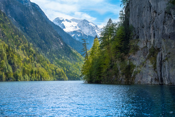 beautiful, picturesque lake Koenigssee in the Alps, in Bavaria, the destination of many tourists from all over the world. Crystal-clear water, which takes on the colors of sky, trees, snow 