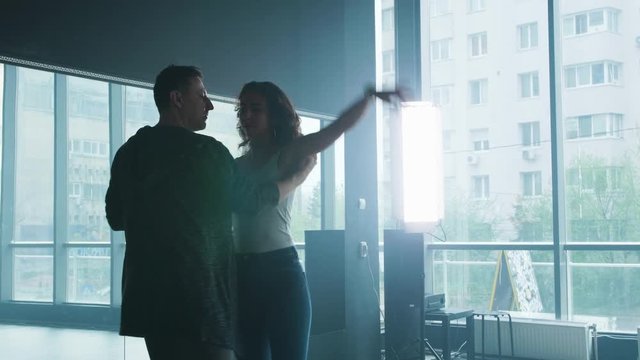 Couple dancing social dance kizomba or bachata in a dance studio. Dancing in passional latino rhythms