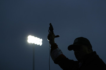 A track official calls runners to their positions