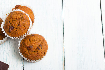 chocolate cupcakes, old white wooden table