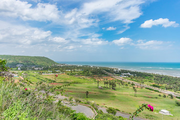 top view of sea beach road looking awesome from top of a mountain with blue sky & beautiful sea view.