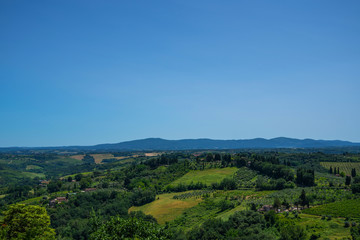 Fototapeta na wymiar Chianti region in summer season. View of countryside and Chianti vineyards from San Gimignano. Tuscany, Italy, Europe. Travel. Beautiful destination. Holiday outdoor vacation trip.