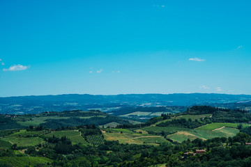 Beautiful landscape of vineyards. Chianti region in summer season. View of countryside and chianti vernaccia vineyards from San Gimignano. Tuscany, Italy, Europe. Summer, holiday, traveling concept.