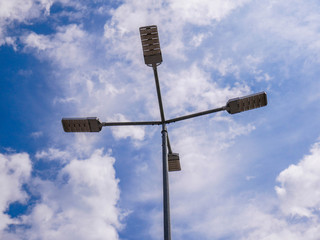 Led street light close up shot, blue sky with white clouds in the background.