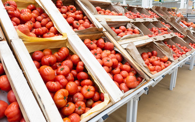 Red tomatoes in wooden boxes. close up.