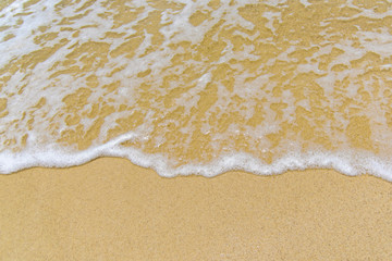 Smooth sand and beautiful waves, suitable as a background for writing messages.