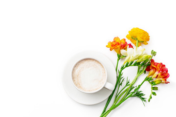 Flatlay with freesia flowers, capuccino cup and copy space on white background