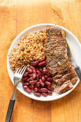 Braised beef steak in red wine with beans & barley