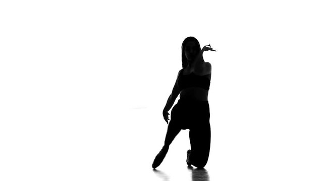 black silhouette on white background girl dancing modern dance, strip plastic