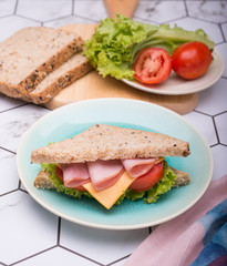 Sandwich with lettuce, tomato, ham and cheese,breakfast