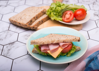 Sandwich with lettuce, tomato, ham and cheese,breakfast