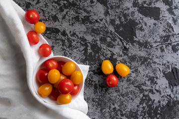cherry tomatoes and yellow plum tomatoes on a grunge table, tomato diet ,vegetarian menus