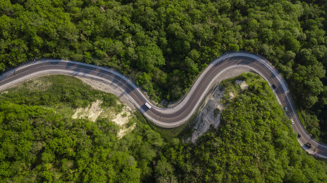 Directly above view: of cars driving on zig zag winding mountain road