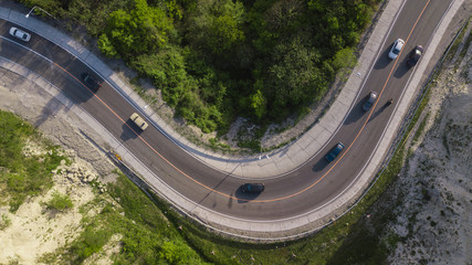 Aerial view of a curved winding road trough the mountains