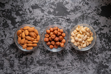 assorted raw nuts in a bowl top view, cashew nuts, almonds, hazelnuts at the kitchens