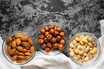 assorted raw nuts in a bowl top view, cashew nuts, almonds, hazelnuts at the kitchens
