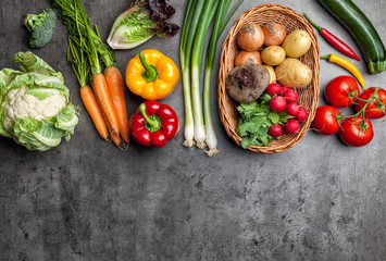 Fresh organic vegetables on rustic background