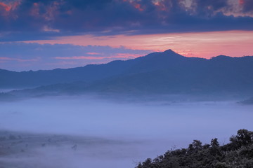 sunrise at Photo Corner Phu Langka View Point, view sea of fog in valley around with the hills with cloudy sky background, route 1148 Phu Langka, Phayao, northern of Thailand.