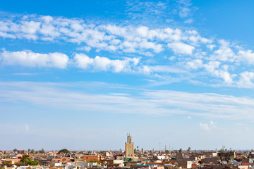 Fototapeta na wymiar Blue Sky with Clouds and a Mosque Minaret in the distance over the Medina of Marrakech Morocco