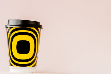 Take-out coffee in thermo cup on a pink background, Copy space