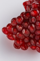 grains of a grenade on a white acrylic background