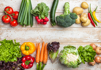 Fresh organic vegetables on rustic background