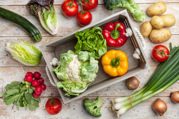 Fresh organic vegetables on rustic background