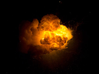 Realistic fiery explosion with sparks over a black background