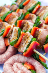 Close up pf delicious chicken breast on wooden skew with fresh vegetables, garlic, paprika fried on mangal barbeque grill and smoke