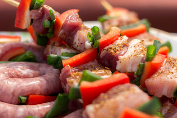 Close up pf delicious chicken breast on wooden skew with fresh vegetables, garlic, paprika fried on mangal barbeque grill and smoke