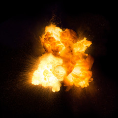 Realistic fiery explosion with sparks over a black background