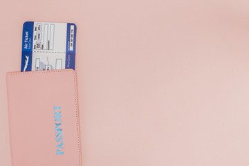 Passport and air ticket on a pink background. Travel concept, copy space