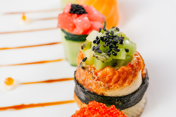Sushi rolls degustation, fusion food style restaurant menu, deluxe gastronomy. Set of finest seafood snacks on white plate