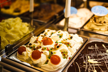 Ice cream fridge with creamy and fruit Italian ice cream steel serving counter with many of refreshing sweet scoopable flavors. Ice cream display, various flavors of gelato ice cream