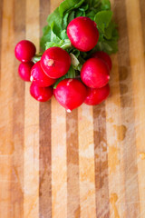 Red fresh radish on wooden background