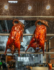 Roasted peking ducks hanging in a street restaurant window in Hong Kong