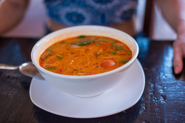 Tom Yam kung Spicy Thai soup with shrimp, seafood, coconut milk and chili pepper in bowl copy space