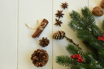 Christmas fir branches with decorations and gift on wooden white board. Toned image with copy space.