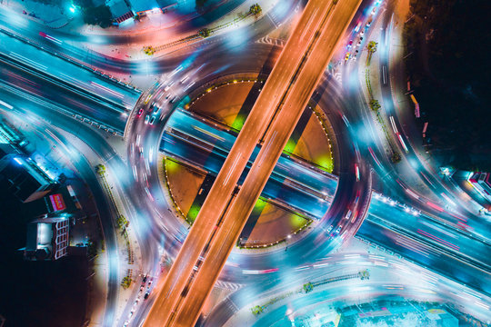 night city traffic on 4-way stop street intersection circle roundabout in Thailand.