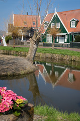 Fototapeta premium Marken - picturesque green wooden houses by a canal in the Dutch island and village Marken