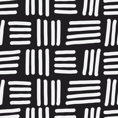 Obraz premium Seamless vector pattern with parallel short lines and stripes. Hand drawn abstract shapes in black and white. Decorative texture for print, textile, packaging, wrapping, web. Isolated repetitive tiles