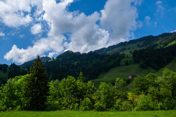 Colorful summer view of small village in the Entlebuch (canton of Lucerne, Switzerland) in summer day. Outdoor scene in Swiss Alps. Beautiful countryside. Nature landscape.