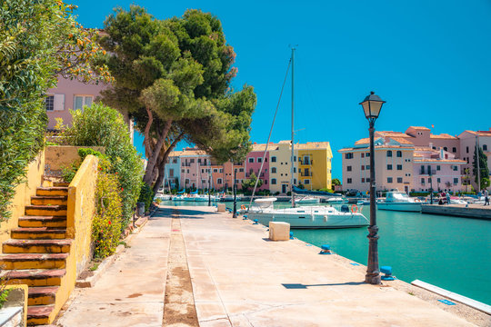 Bright sunny day at Port Saplaya, Valencia's Little Venice. Spain . Yachts docked near  beautiful colorful houses.