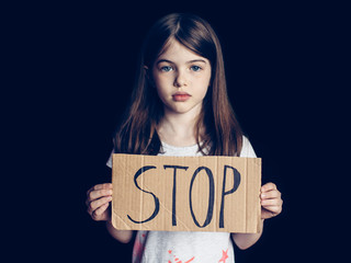 girl holding a stop sign, the concept of the problems of children and adolescents, loneliness,...