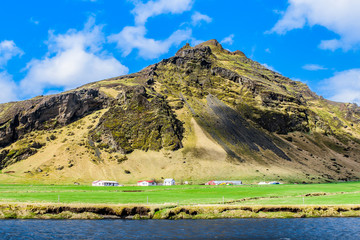 Icelandic landscape. Small village in mountains.