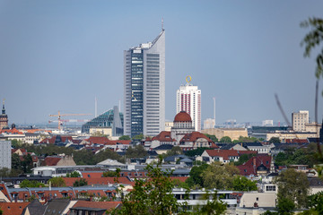 Fototapeta na wymiar Panorama of the city of Leipzig with views of the new city hall, city skyscraper, monument to the Battle of the Nations.Taken from the mountain Fockeberg