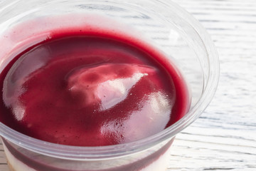 Tiramisu with blueberry mousse in a plastic jar.